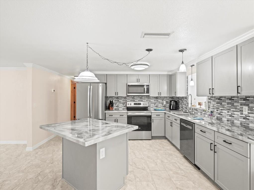 3408 Crape Myrtle Drive Hernando Beach, FL 34607 - Photo 10 of 46 a kitchen with a sink stove and refrigerator
