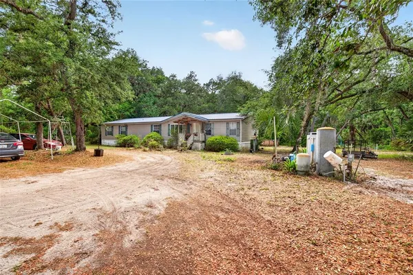 a view of house with outdoor space and swimming pool