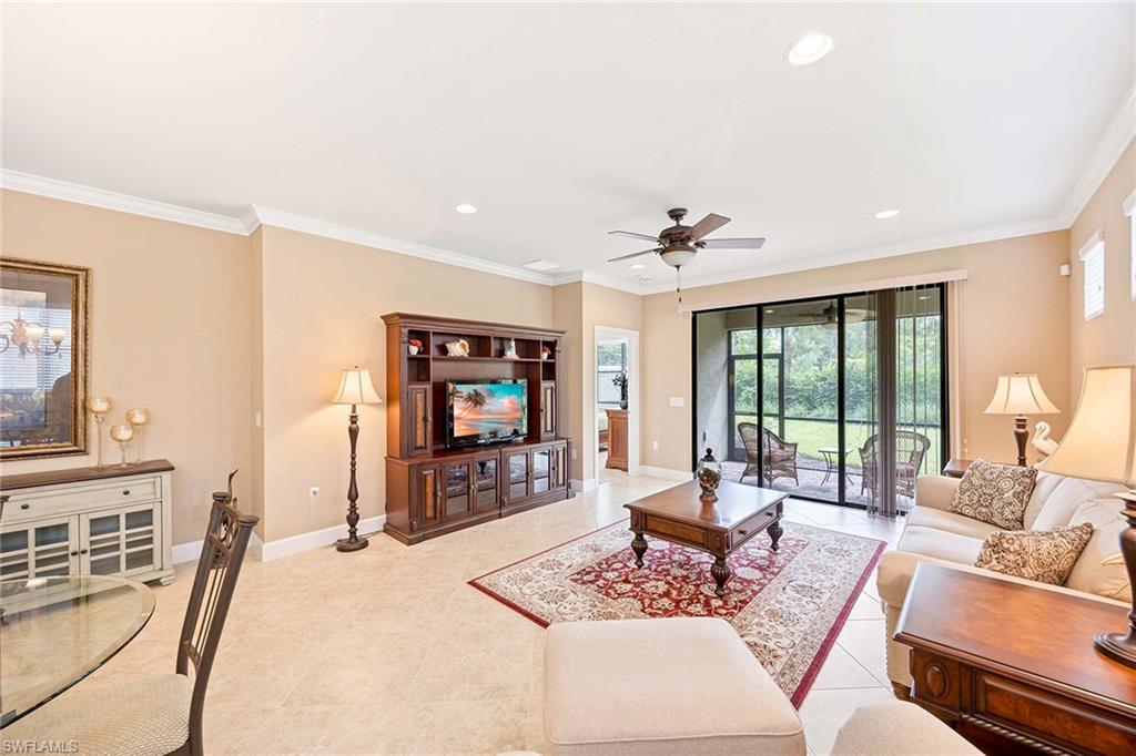 7638 Jacaranda Lane Naples, FL 34114 - Photo 15 of 50 a living room with furniture a flat screen tv and a large window