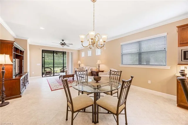 a view of a dining room with furniture a chandelier and wooden floor