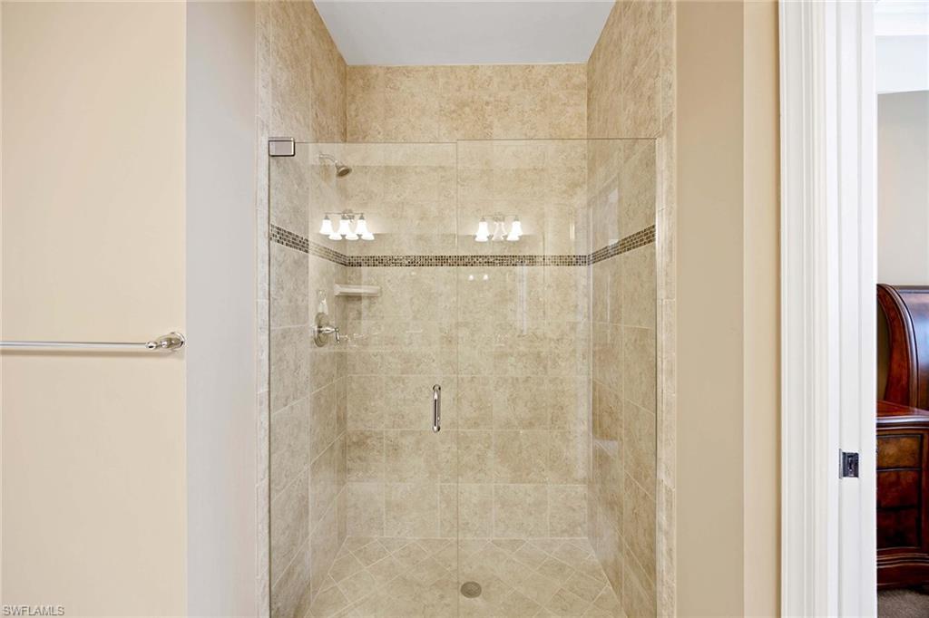 7638 Jacaranda Lane Naples, FL 34114 - Photo 22 of 50 a bathroom with a glass shower door