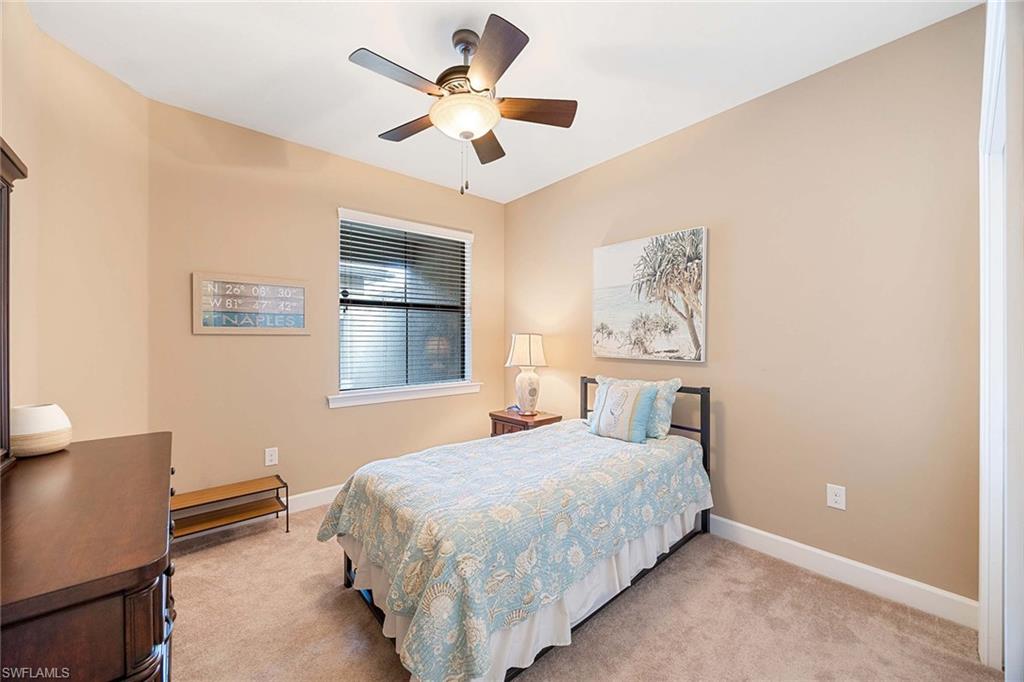 7638 Jacaranda Lane Naples, FL 34114 - Photo 24 of 50 a bedroom with a large bed and a window