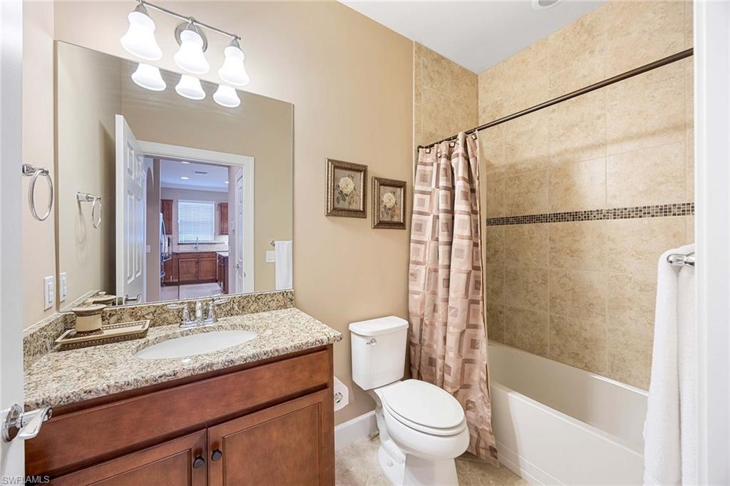 7638 Jacaranda Lane Naples, FL 34114 - Photo 25 of 50 a bathroom with a granite countertop sink toilet and shower
