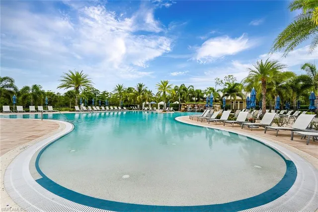 a view of a swimming pool with outdoor seating