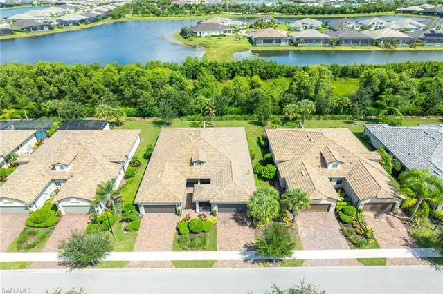 an aerial view of a house with a garden and lake view