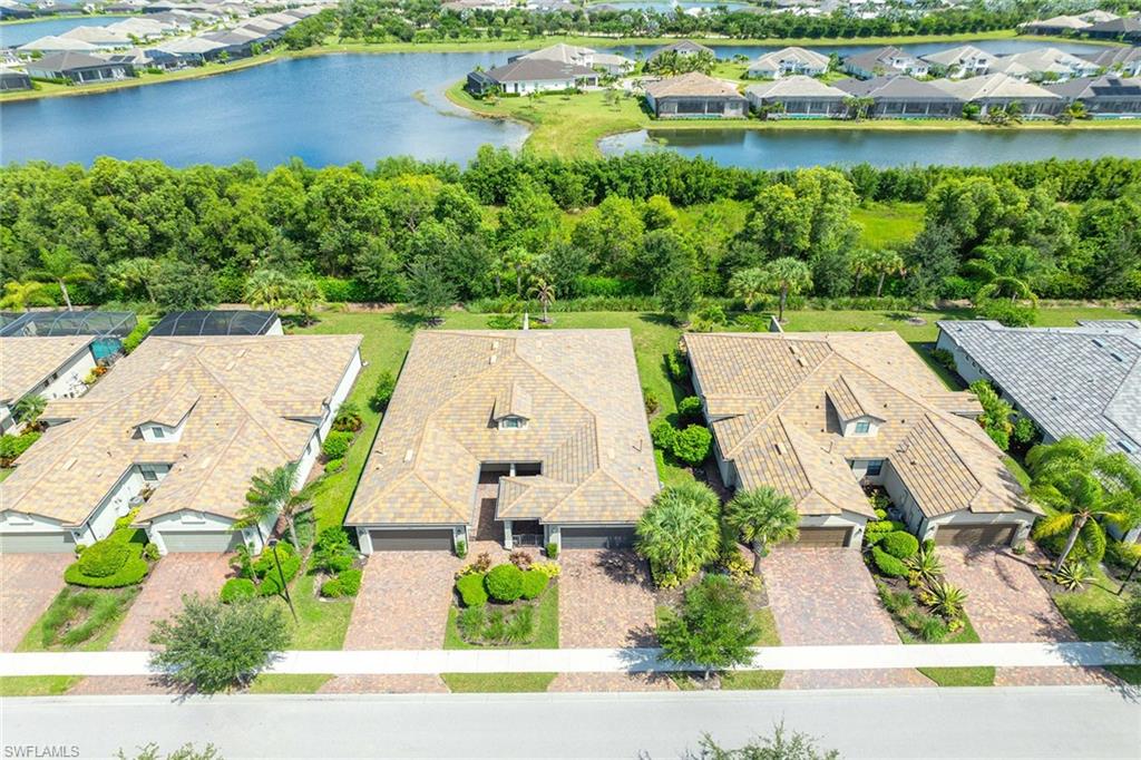 7638 Jacaranda Lane Naples, FL 34114 - Photo 6 of 50 an aerial view of a house with a garden and lake view