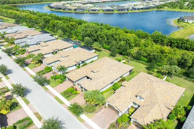 an aerial view of a house with a garden and lake view