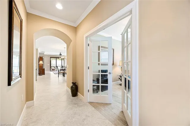 a view of a hallway with wooden floor and dining room