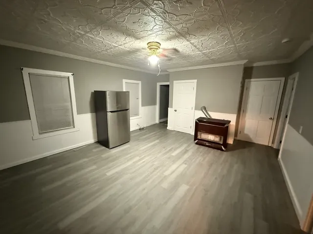 a view of kitchen with furniture and a refrigerator
