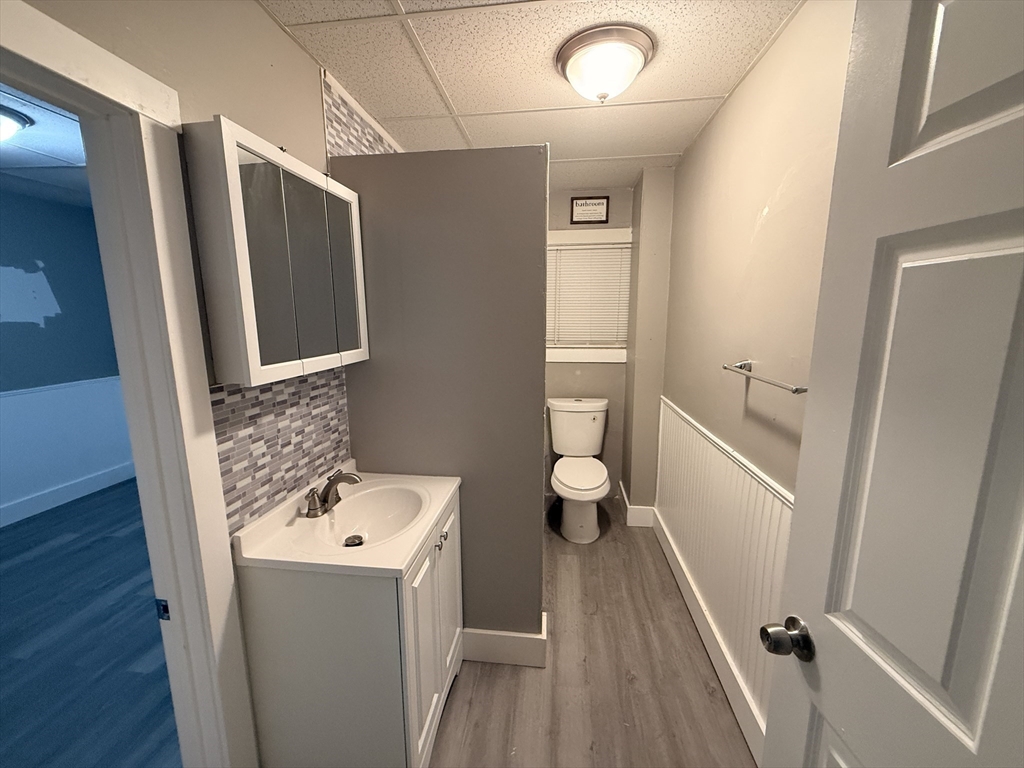 107-113 Palmer Street, Unit 3 Fall River, MA 02724 - Photo 5 of 8 a bathroom with a sink a toilet and a mirror