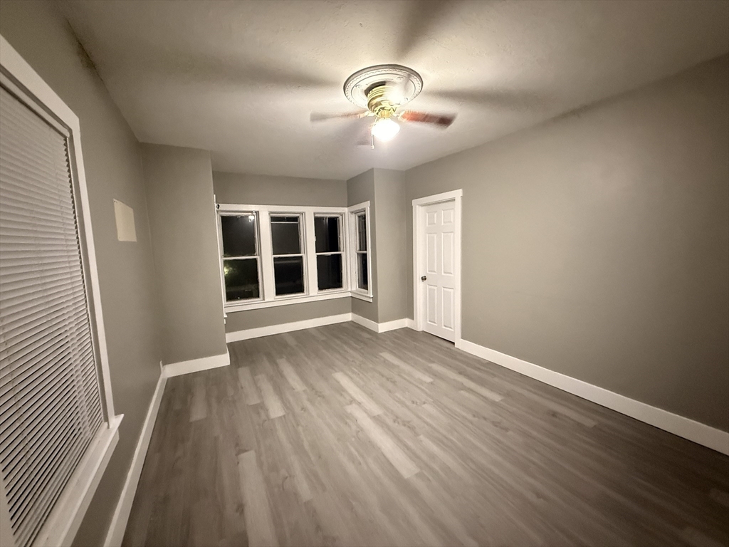 107-113 Palmer Street, Unit 3 Fall River, MA 02724 - Photo 6 of 8 an empty room with wooden floor and windows