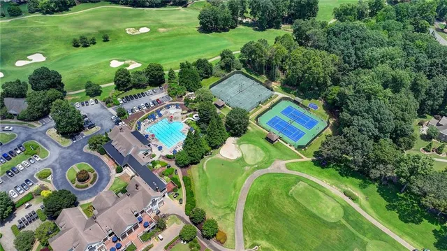 an aerial view of a swimming pool patio and outdoor seating