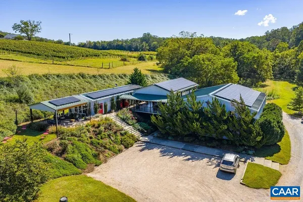 a living room with furniture a large window with wooden floor