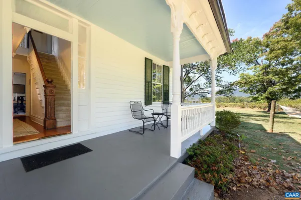 a spacious bedroom with a bed and glass windows