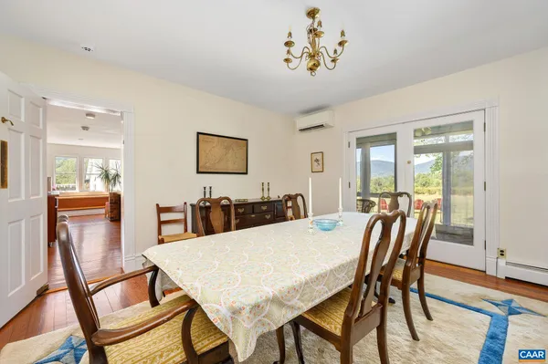 a bedroom with a bed a chandelier and dresser
