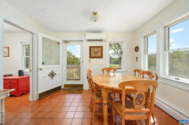 a view of a hallway with wooden floor and windows