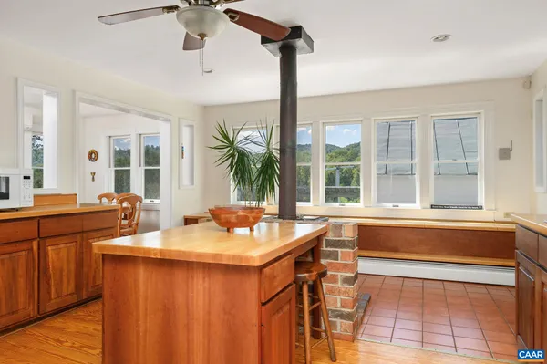 a bedroom with a bed wooden floor and window