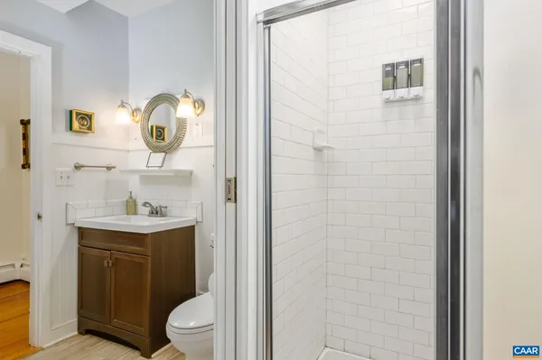 a bedroom with a bed and painting on the wall