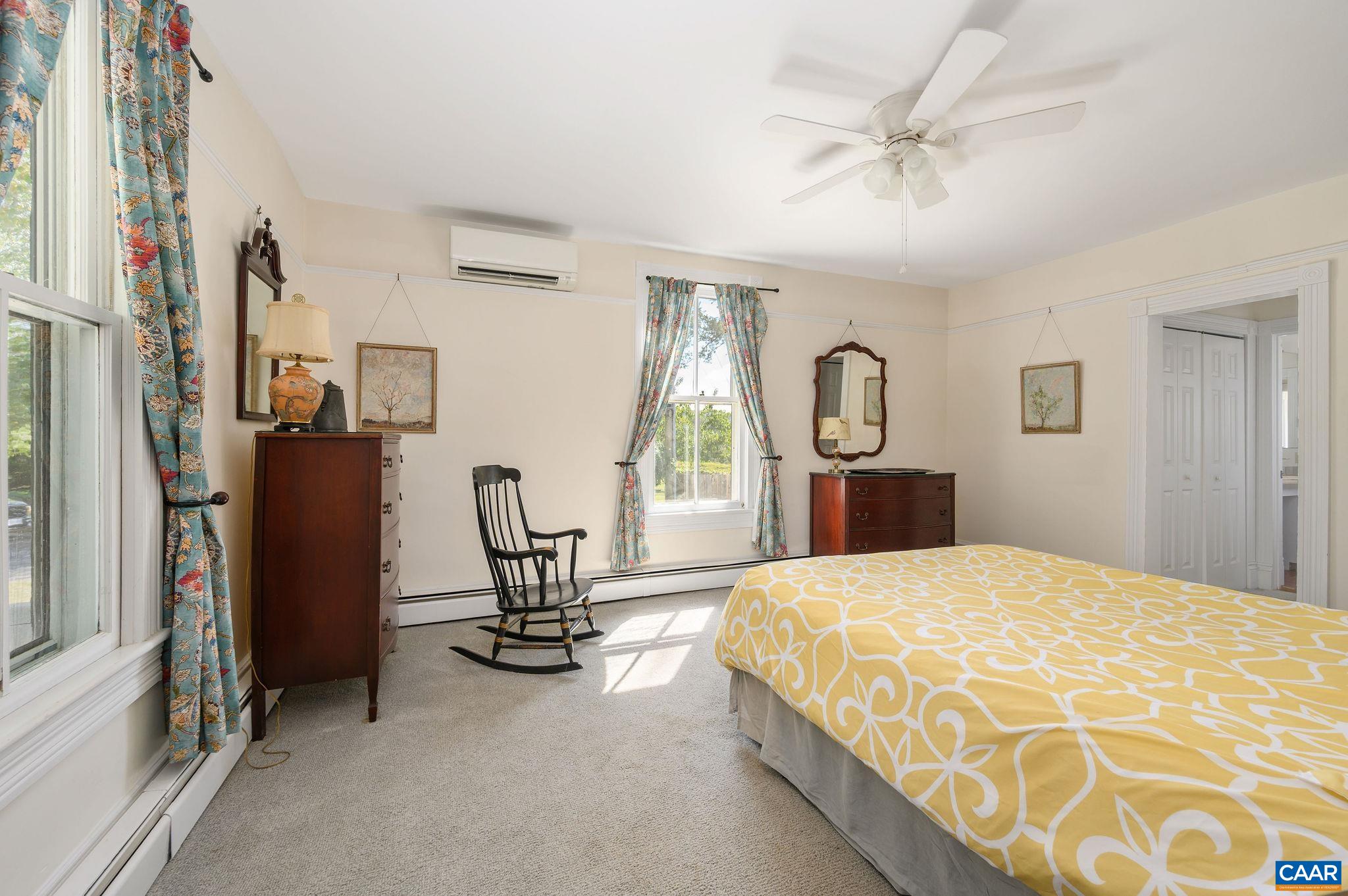 9175 Batesville Road Afton, VA 22920 - Photo 29 of 74 a bedroom with a bed a chandelier and dresser