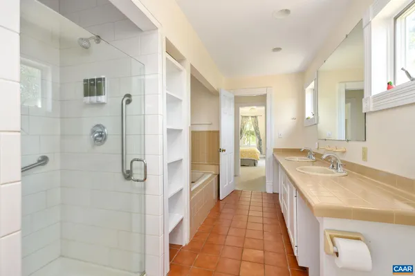 a view of swimming pool with a garden and deck