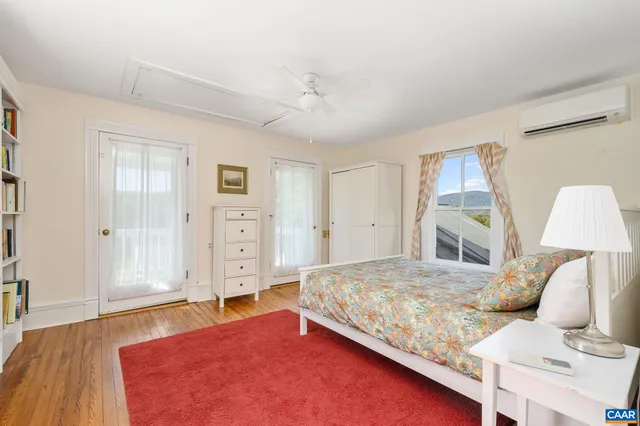 a view of a green field with trees in the background