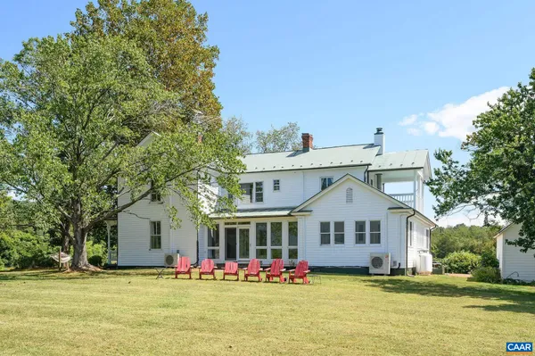 a view of a house with a yard and sitting area
