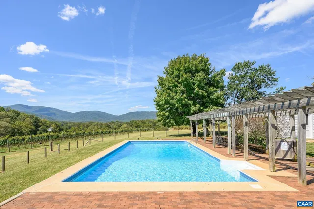 a view of a living room with furniture and a kitchen