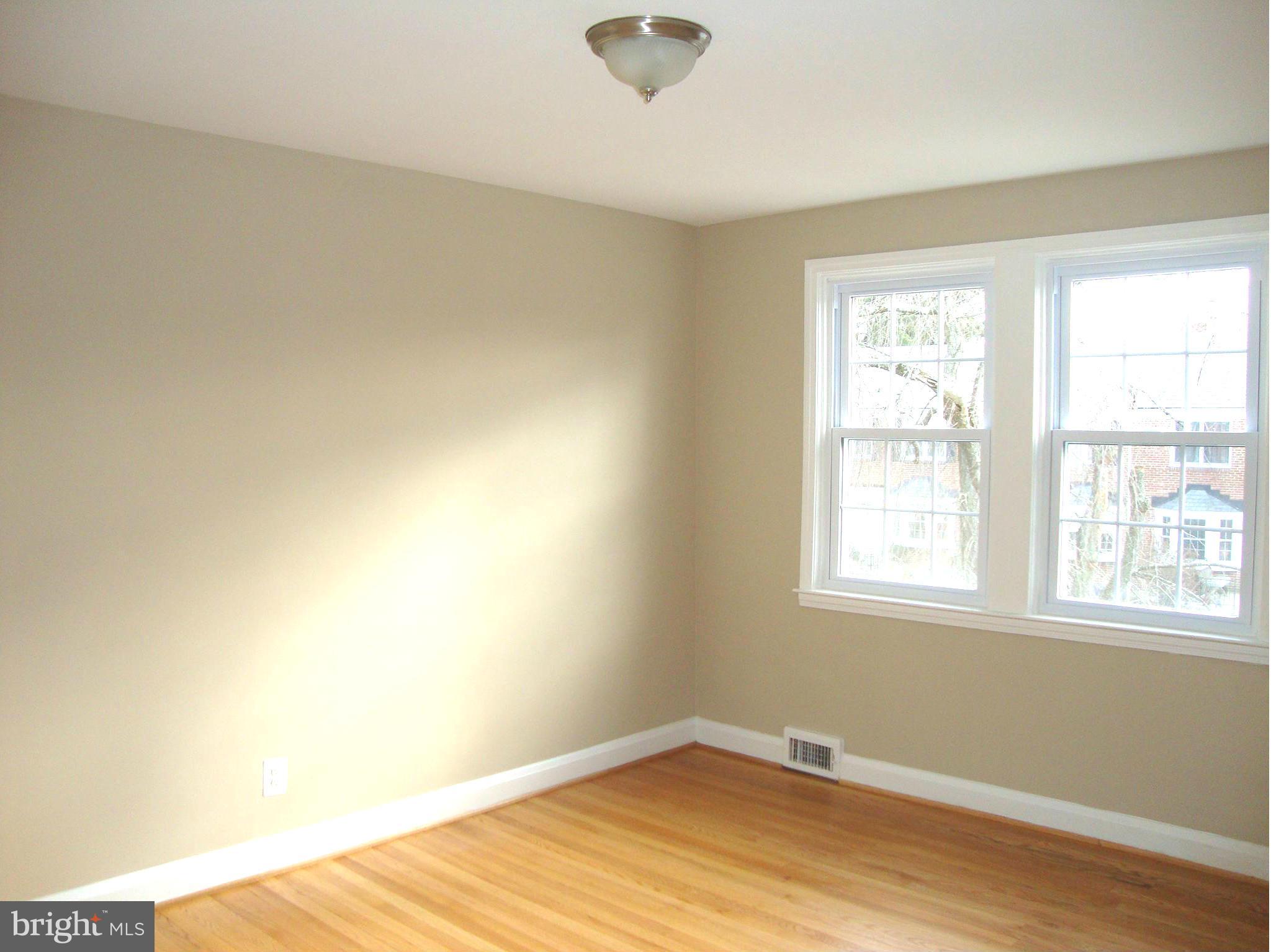 116 Overbrook Road Baltimore, MD 21212 - Photo 14 of 30 an empty room with wooden floor and windows