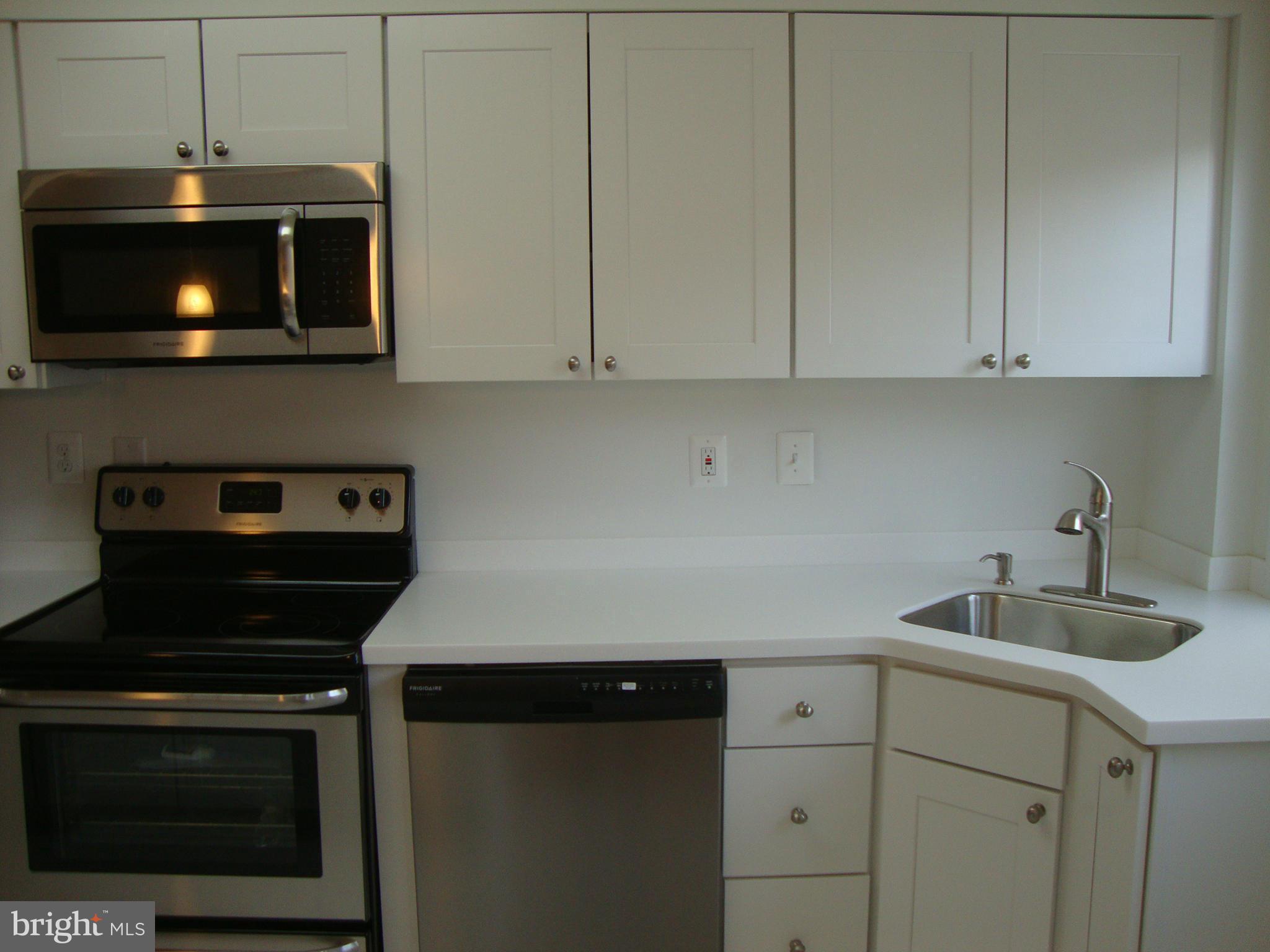 116 Overbrook Road Baltimore, MD 21212 - Photo 8 of 30 a kitchen with a stove and a microwave