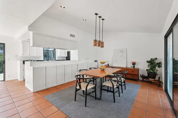 a kitchen with granite countertop a sink stove and cabinets