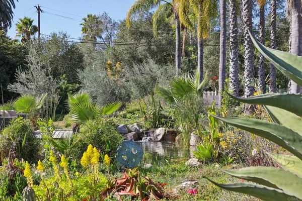 a view of a backyard with sitting area