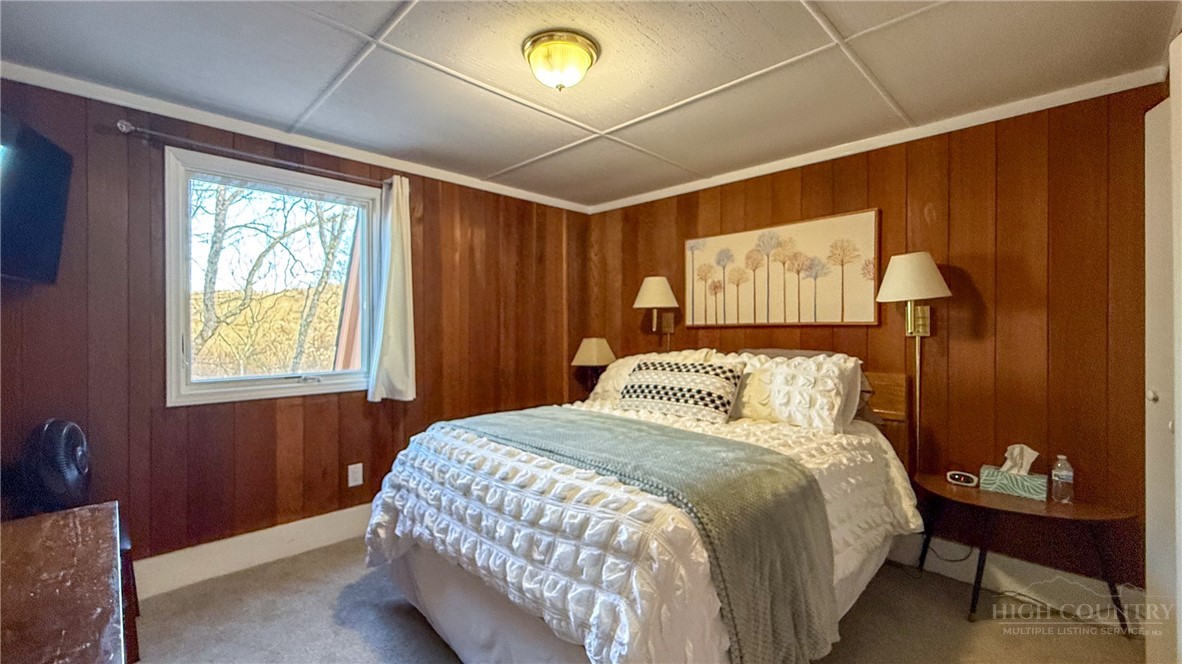 220 Charter Hills Road, Unit C3 Beech Mountain, NC 28604 - Photo 14 of 32 a bedroom with a bed and a window