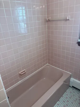 a bath tub sitting next to a white sink