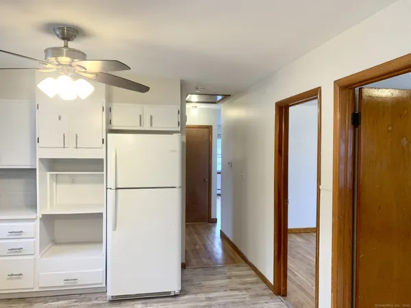 a view of a kitchen with a refrigerator and a ceiling fan