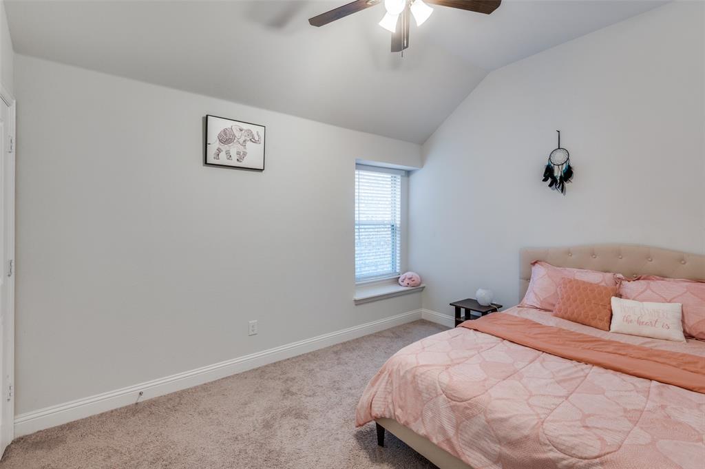 1216 Collett Sublett Road Kennedale, TX 76060 - Photo 13 of 25 a bedroom with a bed and a chandelier