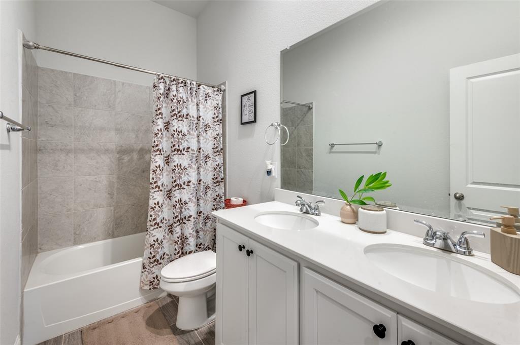1216 Collett Sublett Road Kennedale, TX 76060 - Photo 15 of 25 a bathroom with a sink a toilet and shower