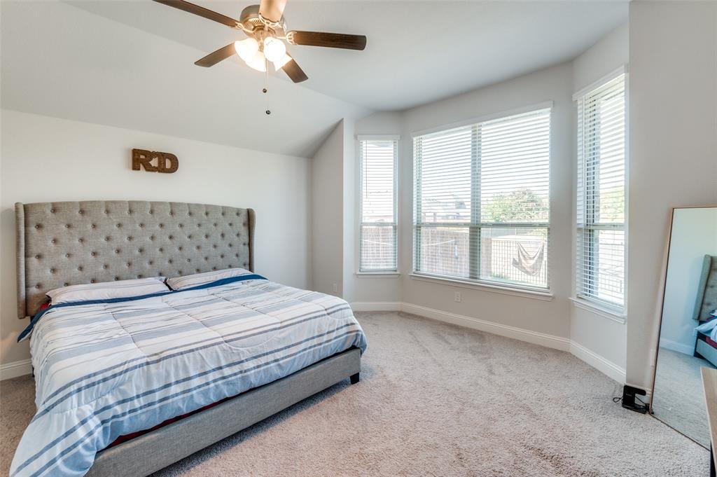 1216 Collett Sublett Road Kennedale, TX 76060 - Photo 17 of 25 a bedroom with a large bed and a chandelier fan