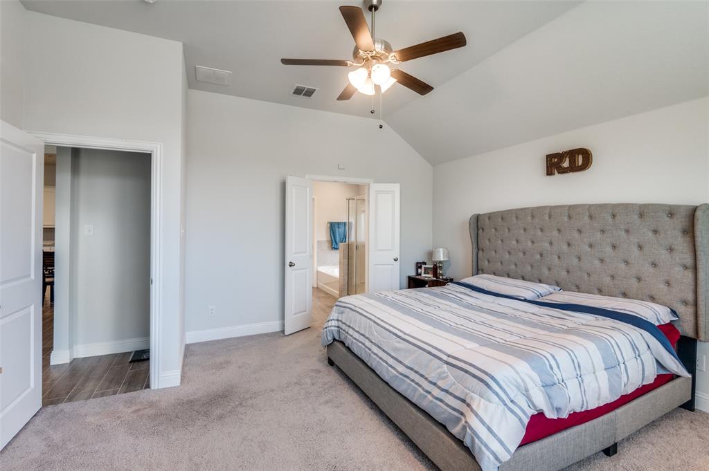 1216 Collett Sublett Road Kennedale, TX 76060 - Photo 19 of 25 a bedroom with bed and a chandelier