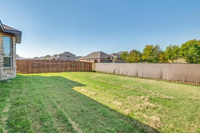 a view of a house with a yard and sitting area