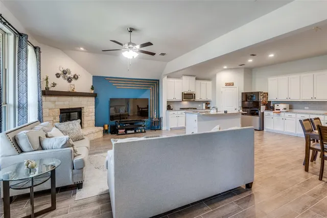 a living room with fireplace furniture and a flat screen tv
