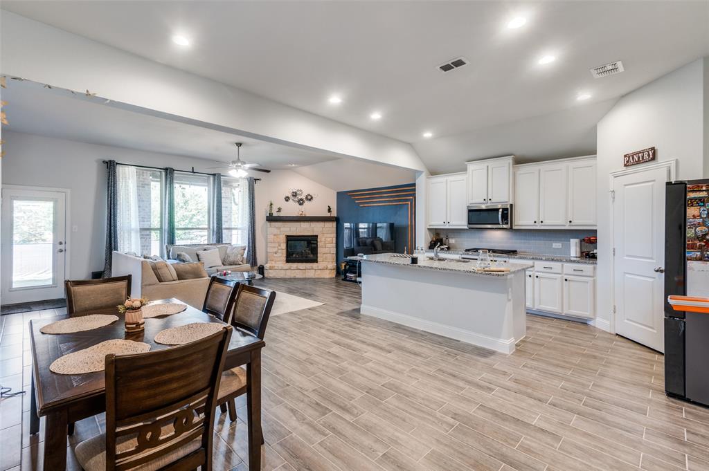 1216 Collett Sublett Road Kennedale, TX 76060 - Photo 25 of 25 a living room with kitchen island furniture and a fireplace