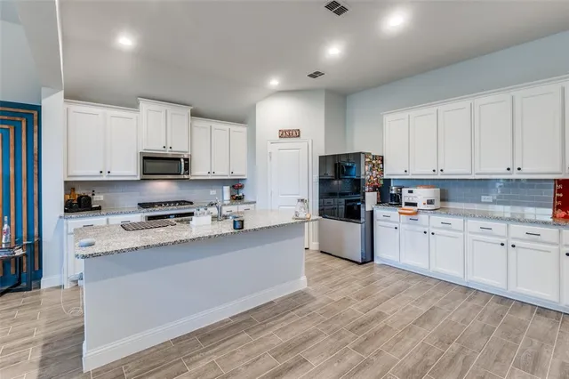 a living room with kitchen island furniture and a fireplace