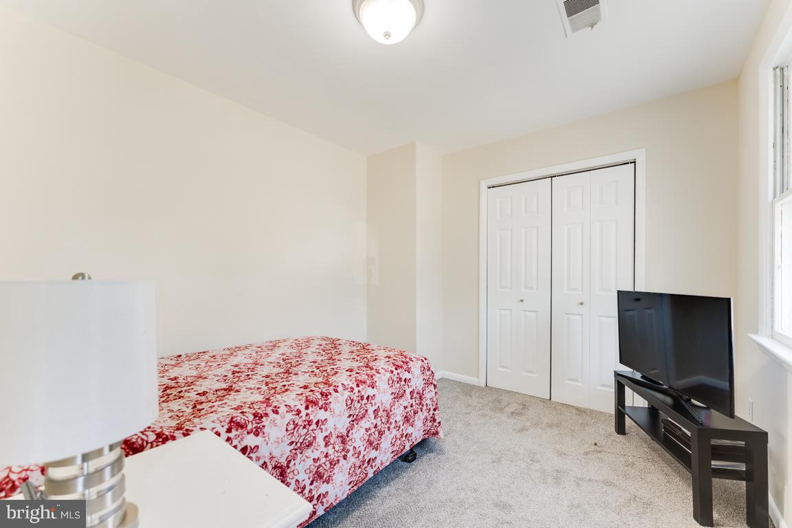 2504 Weisman Road Silver Spring, MD 20902 - Photo 20 of 30 a bedroom with a bed and a flat screen tv