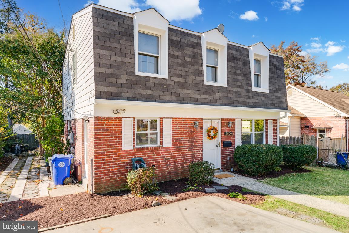 2504 Weisman Road Silver Spring, MD 20902 - Photo 2 of 30 a view of a building next to a yard