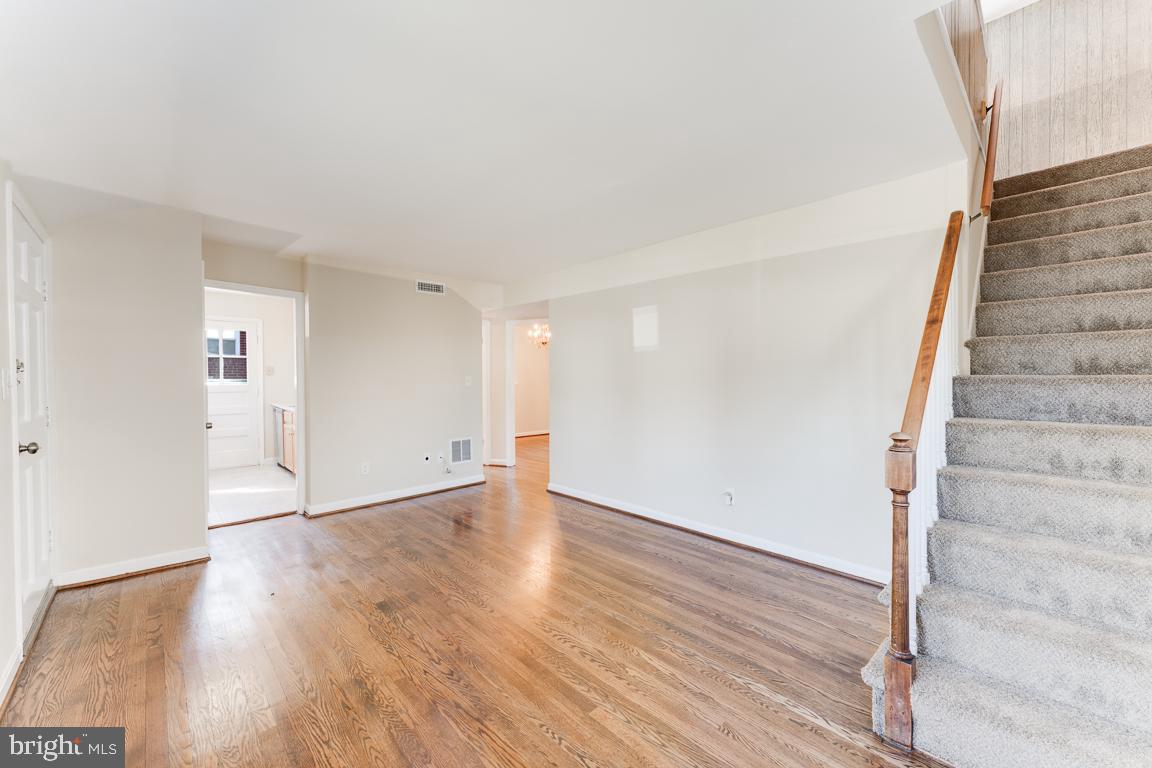 2504 Weisman Road Silver Spring, MD 20902 - Photo 6 of 30 a view of an empty room with wooden floor and stairs