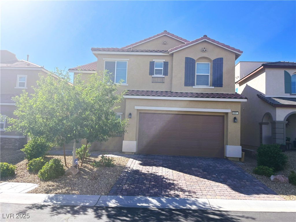 Mediterranean / spanish home with an attached gara