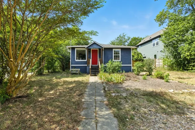 a view of a house with yard and a garden