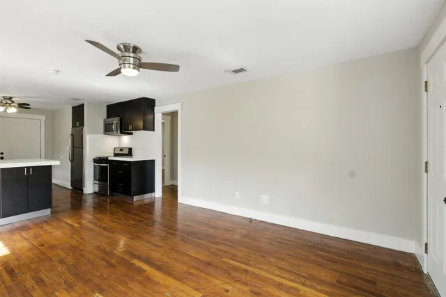 a view of a kitchen with wooden floor