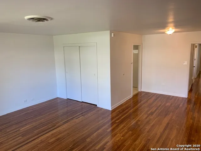 a view of hallway with wooden floor