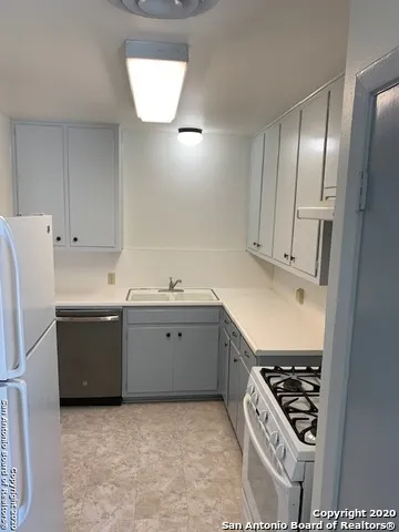 a kitchen with a stove and a refrigerator